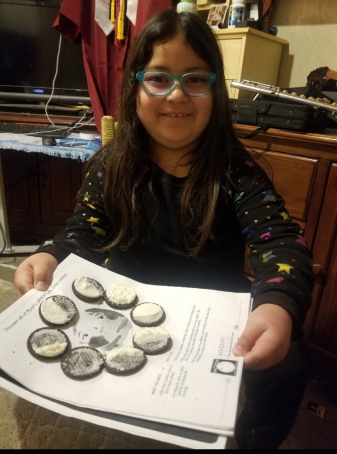 A student shows the phases of the moon using Oreos— a project that captivated children and families alike.